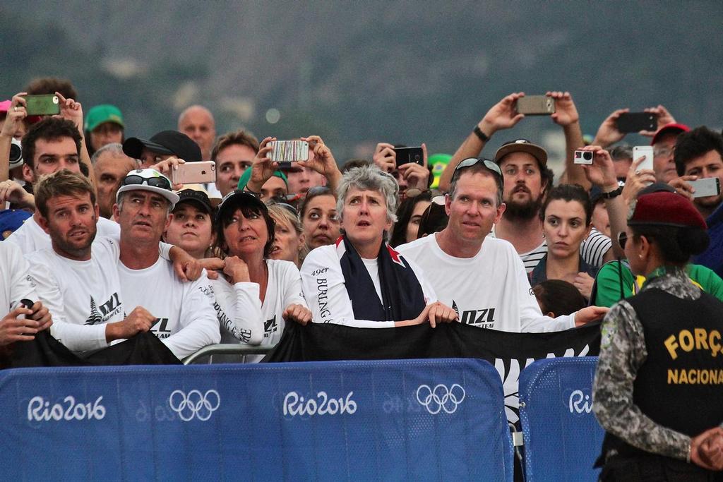 NZ Mens 49er Supporters watch the NZ ensign raised at the 49er Medal Ceremony © Richard Gladwell www.photosport.co.nz